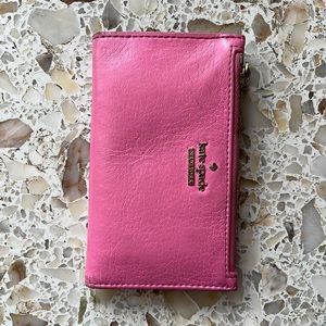 Hot pink wallet with coin pouch. Shows signs of wear.